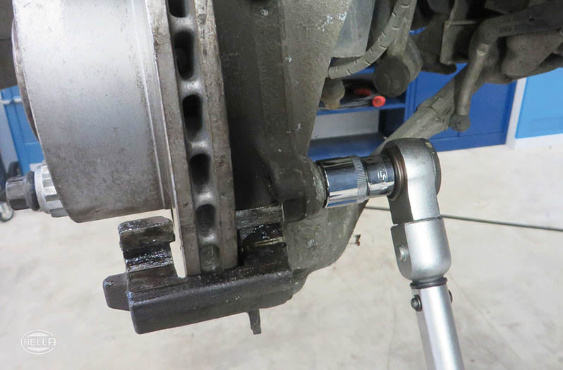 Install the caliper anchor bracket