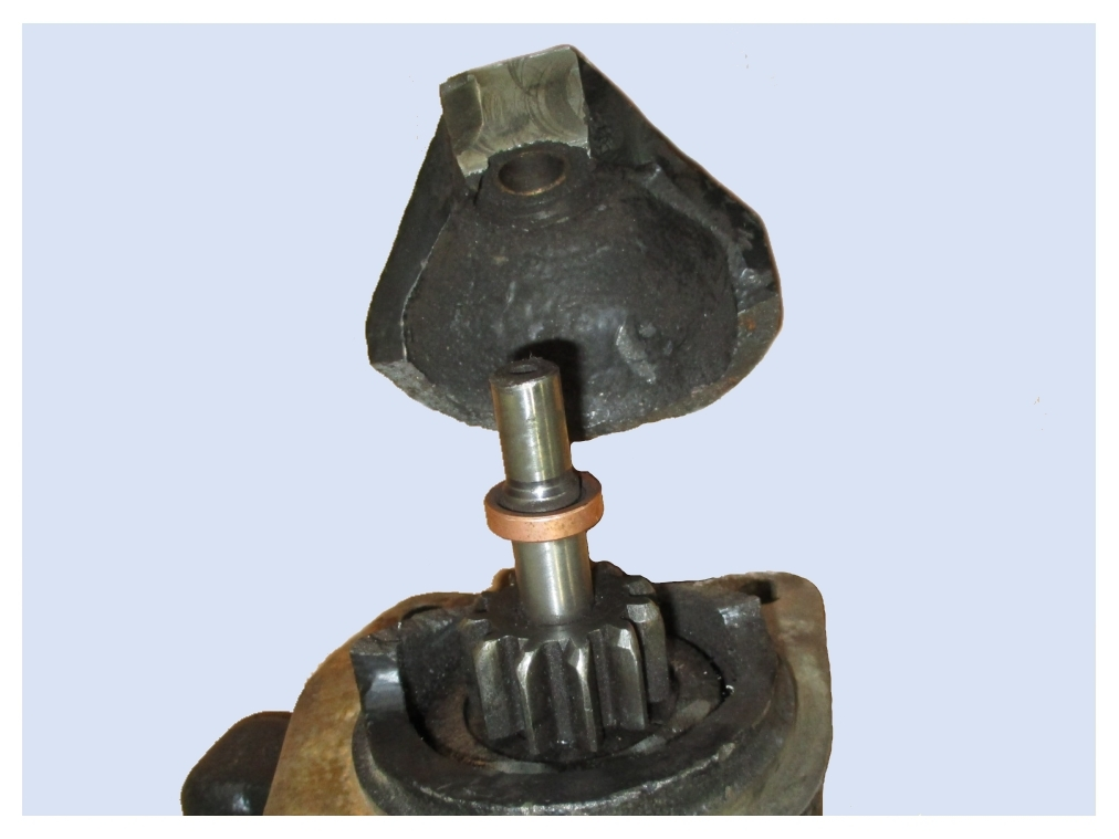 Broken end shield with exposed pinion shaft